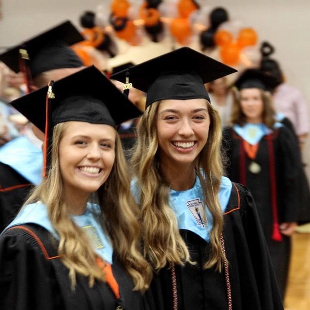 girls wearing cap and gowns